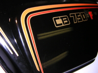 1979 cb750f black side cover with new stripes and logo installed.